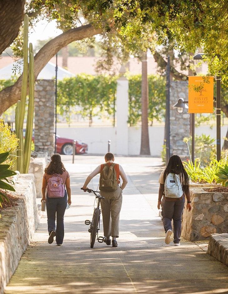 three students walk on avery walkway towards scripps college. 